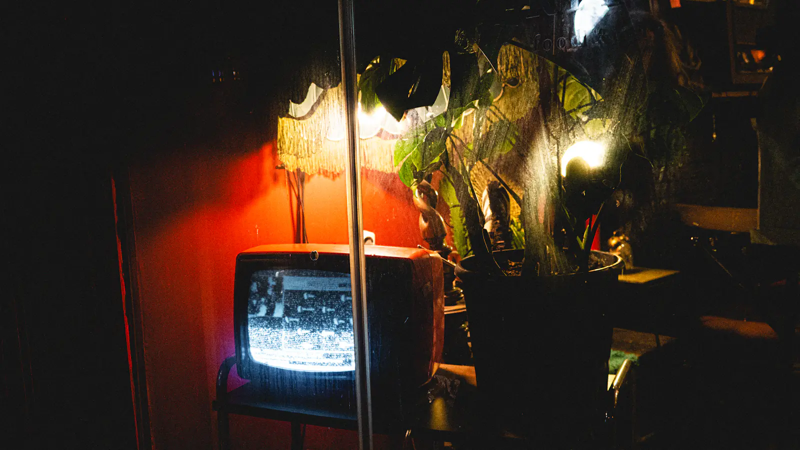 Vintage television glowing with static in a dark room, illustrating the TV roots of the parasocial relationship idea